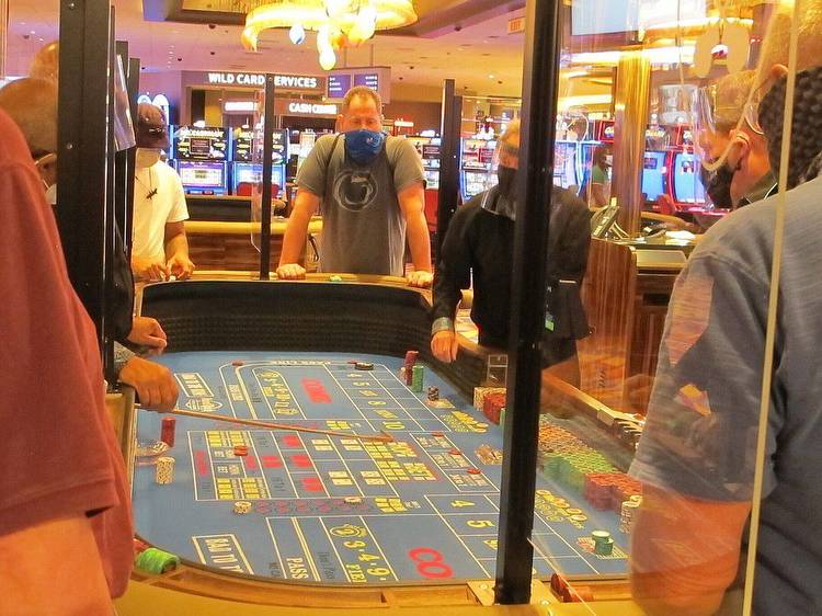 This July 2, 2020 photo shows a game of craps underway at the Hard Rock casino in Atlantic City N.J. On May 3, 2021, Hard Rock officials told The Associated Press they will spend $20 million on renovations, the latest in a line of Atlantic City casinos to reinvest during the coronavirus pandemic. (AP Photo/Wayne Parry)